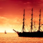 Tall ship sailing in red